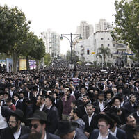 Illustrative: Ultra-Orthodox Jews attend the funeral of Rabbi Chaim Kanievsky in Bnei Brak, March 20, 2022. (AP Photo/Oded Balilty)