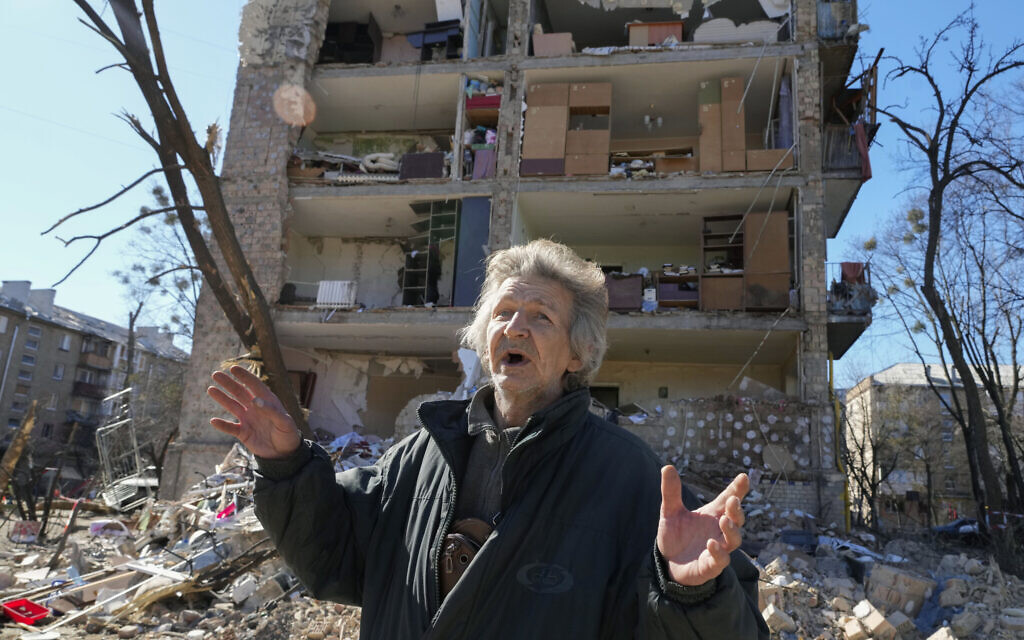 A man reacts standing near his house ruined after Russian shelling in Kyiv, Ukraine, Monday, March 21, 2022. At least eight people were killed in the attack. (AP/Efrem Lukatsky)