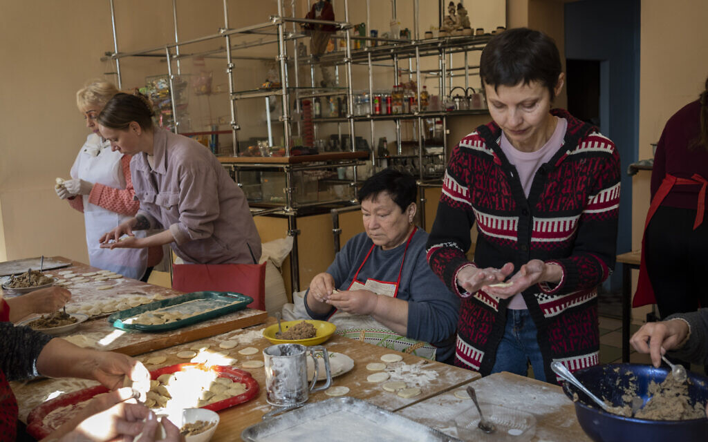 Volunteers prepare varenyky, stuffed dumplings, inside a theatre in the city of Drohobych, western Ukraine, Monday, March 21, 2022. (AP/Bernat Armangue)