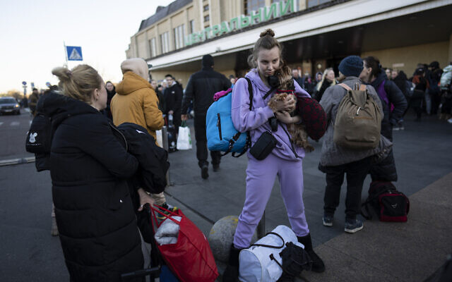 Daryna Kovalenko, 19 , holds her dog Tim, while arriving at Kyiv's train station after leaving her home in Chernihiv, Ukraine, through a humanitarian corridor, Monday, March 21, 2022. (AP/Rodrigo Abd)