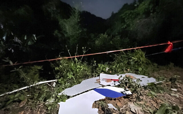 In this photo released by China's Xinhua News Agency, debris is seen at the site of a plane crash in Tengxian County in southern China's Guangxi Zhuang Autonomous Region, Tuesday, March 22, 2022. A China Eastern Boeing 737-800 with more than 100 people on board crashed in a remote mountainous area of southern China on Monday, officials said, setting off a forest fire visible from space in the country's worst air disaster in nearly a decade. (Zhou Hua/Xinhua via AP)