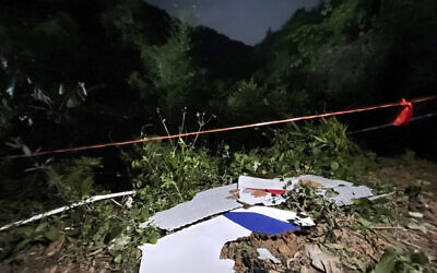 In this photo released by China's Xinhua News Agency, debris is seen at the site of a plane crash in Tengxian County in southern China's Guangxi Zhuang Autonomous Region, March 22, 2022. (Zhou Hua/Xinhua via AP)