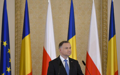Poland's President Andrzej Duda listens to Romania's President Klaus Iohannis during press statements at the Presidential Palace in Bucharest, Romania, March 22, 2022. (AP Photo/Andreea Alexandru)