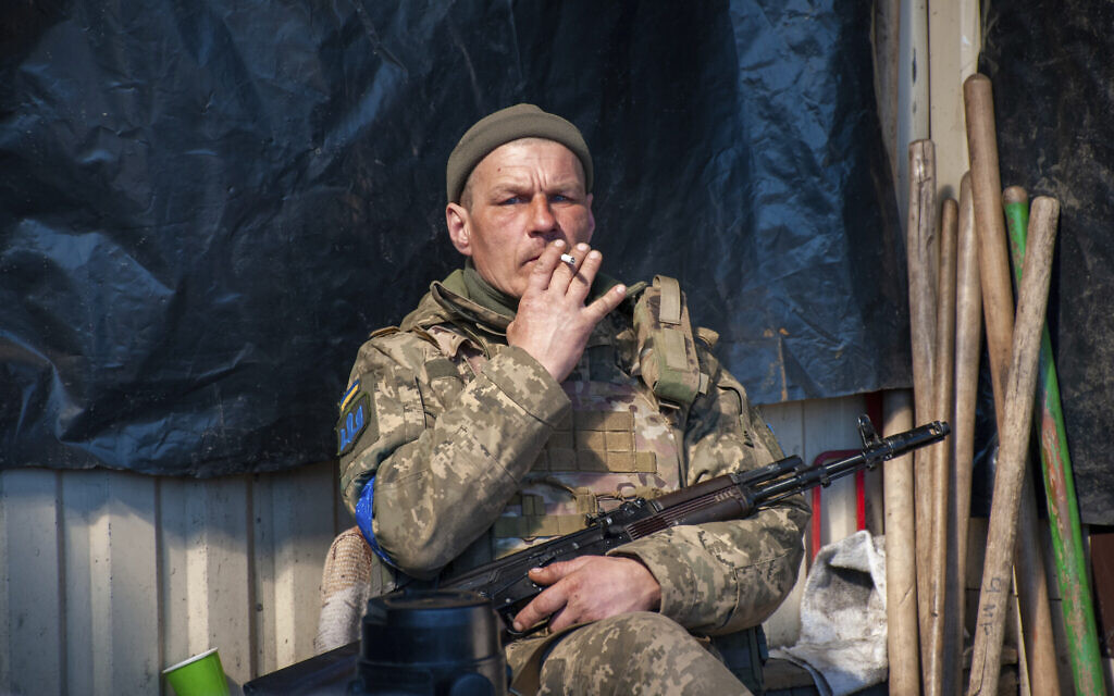A Ukrainian serviceman has a rest on his position in Kharkiv, Ukraine, Tuesday, March 22, 2022. (AP/Andrew Marienko)