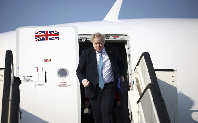 Britain's Prime Minister Boris Johnson disembarks a plane to attend a special meeting of NATO leaders in Brussels, Belgium, March 24, 2022. (Henry Nicholls/Pool Photo via AP)