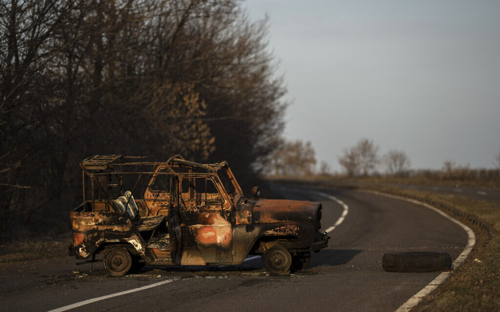 A burned Ukranian army vehicle stands on a street leading to the airport of the city of Mykolaiv, Ukraine, March 25, 2022.(AP Photo/Petros Giannakouris)