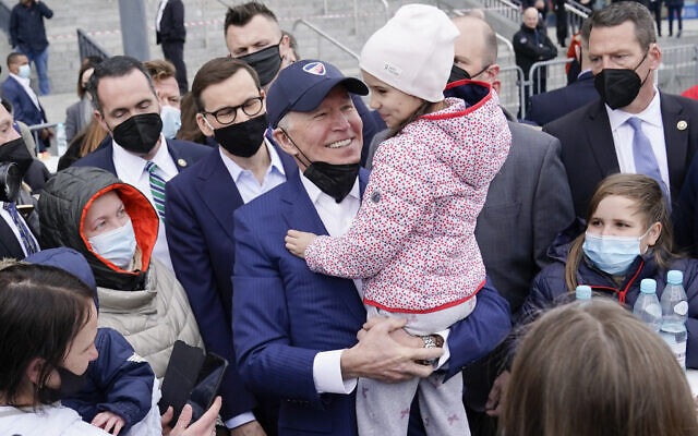 US President Joe Biden meets with Ukrainian refugees during a visit to PGE Narodowy Stadium, on Saturday, March 26, 2022, in Warsaw. (AP Photo/Evan Vucci)