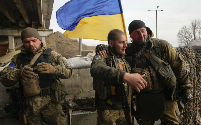 Ukrainian soldiers chat in the front line position close to Kharkiv, Ukraine, March 26, 2022. (AP Photo/Efrem Lukatsky)