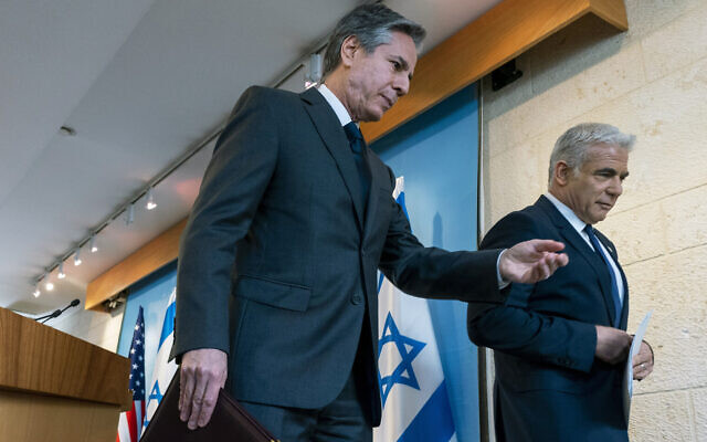 US Secretary of State Antony Blinken, left, and Israel's Foreign Minister Yair Lapid walk together after a news conference, March 27, 2022, at Israel's Ministry of Foreign Affairs in Jerusalem. (AP Photo/Jacquelyn Martin, Pool)