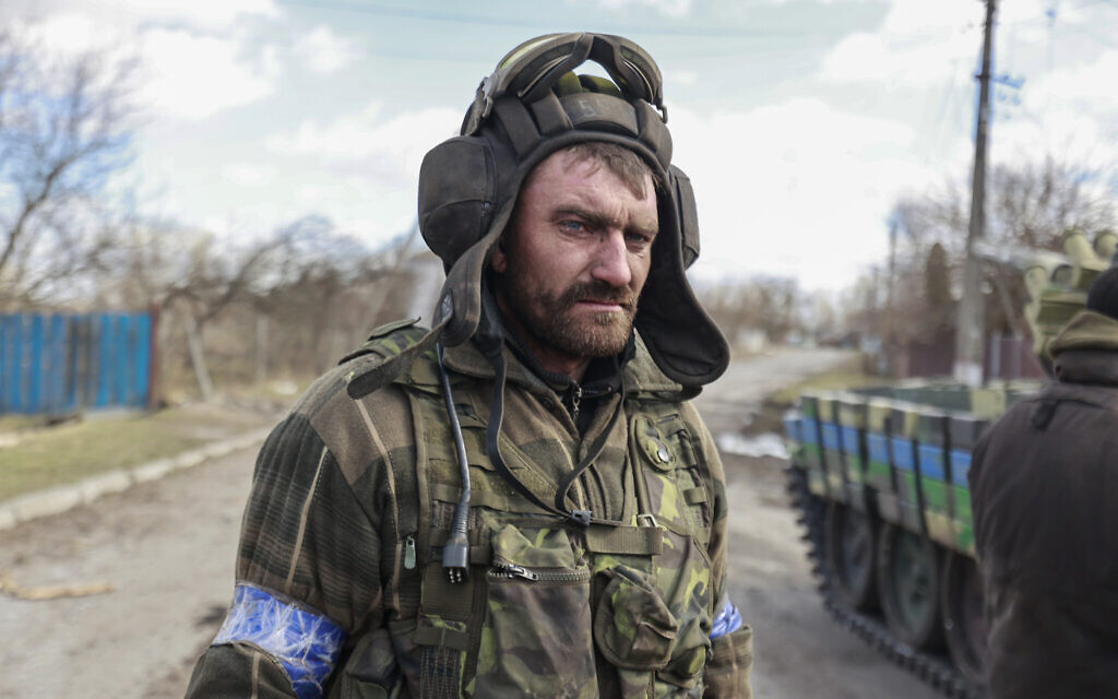 A Ukrainian serviceman stands in a street in Lukyanivka, Kyiv region, Ukraine, March 27, 2022. (AP Photo)
