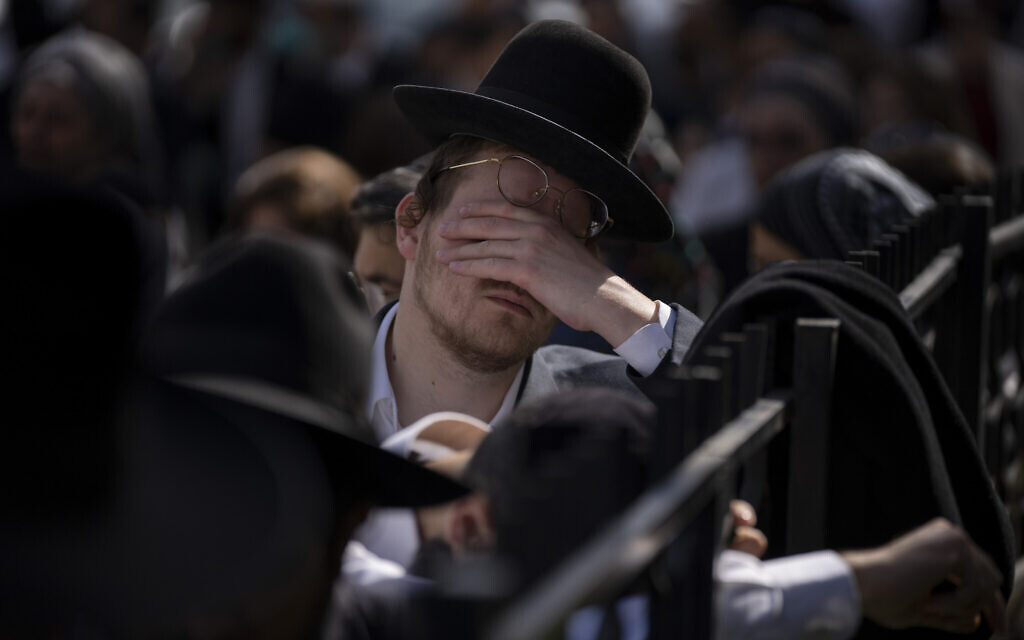Mourners attend the funeral of Avishai Yehezkel, 29, in Bnei Brak, March 30, 2022 (AP Photo/Oded Balilty)
