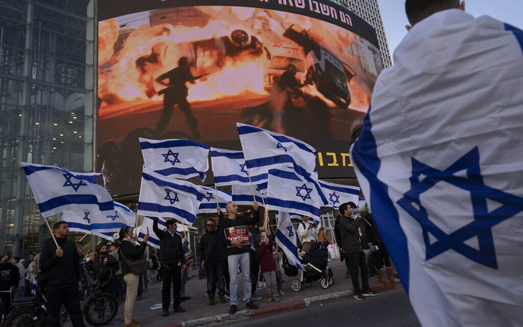 Right wing activists wave Israeli flags during a protest against Israel's Prime Minister Naftali Bennett, following a recent wave of violence, in Tel Aviv, Israel, Wednesday, March 30, 2022. (AP/Oded Balilty)