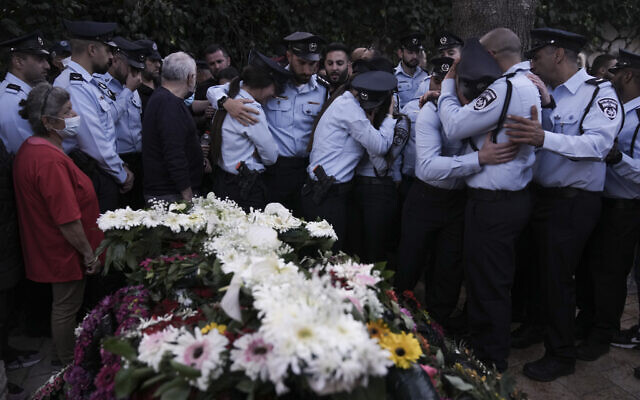 Israeli police officers weep for their slain colleague, Christian police officer Amir Khoury during his funeral in Nof Hagalil, Israel, Thursday, March 31, 2022. (AP Photo/Ariel Schalit)