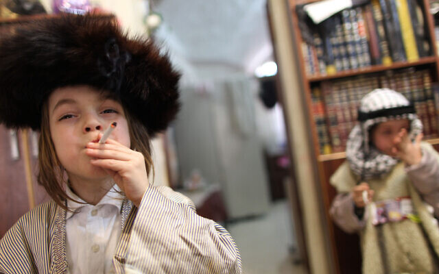 An ultra-Orthodox boy dressed up in costume smoking a cigarette on Purim of 2011. (Nati Shohat/Flash90)