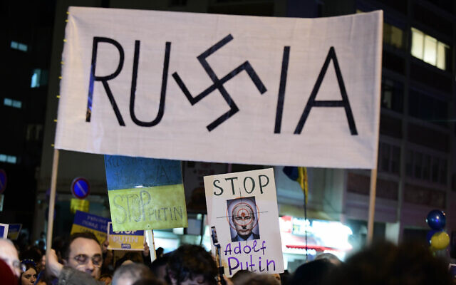 Demonstrators carry placards and flags during a protest against the Russian invasion to the Ukraine, outside the Russian Embassy in Tel Aviv, March 5, 2022. (Tomer Neuberg/Flash90)