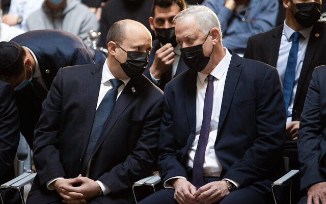Prime Minister Naftali Bennett and Defense Minister Benny Gantz attend the annual ceremony for soldiers whose burial places are unknown, at Mount Herzl national cemetery in Jerusalem, on March 10, 2022. (Alex Kolomoisky/Pool/Flash90)