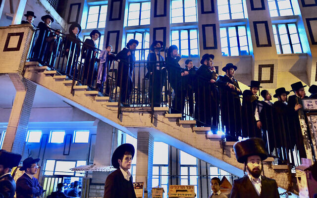 People gather outside the home of Rabbi Haim Kanievsky who passed away, in the city of Bnei Brak, on March 19, 2022.(Avshalom Sassoni/ Flash90)