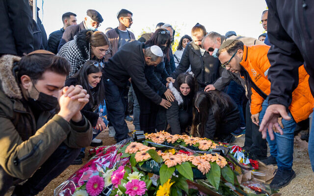 Mourners attend the funeral of 49-year-old Doris Yahbas, who was killed in a terror attack in Beersheba, at a cemetery in Moshav Gilat, March 23, 2022. (Flash90)
