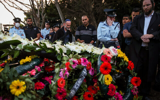People pay their respects during the funeral of Police officer Amir Khoury who was killed in a firefight at a terrorist shooting attack in Bnei Brak, at the cemetery in Nof Hagalil, March 31, 2022. (David Cohen/Flash90)