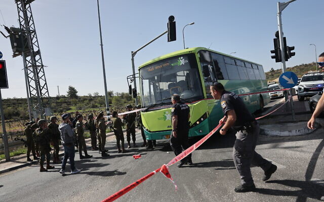 Israeli soldiers, police, and medics are seen at the scene of a stabbing attack near the Neve Daniel junction in the West Bank, March 31, 2022. (Yonatan Sindel/FLASH90)