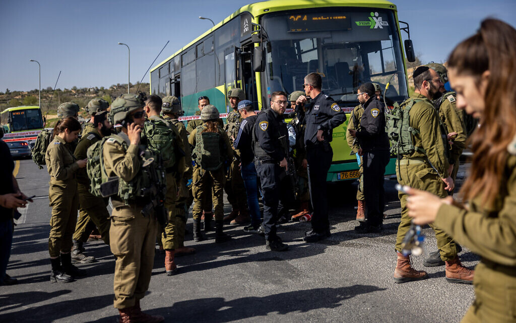 Israeli soldiers, police, and medics are seen at the scene of a stabbing attack near the Neve Daniel junction in the West Bank, March 31, 2022. (Yonatan Sindel/FLASH90)