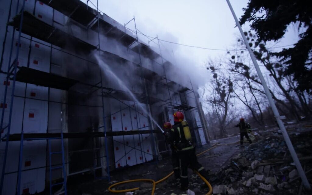 Ukrainian firefighters work to put out a blaze in a building in the Jewish cemetery located in Kyiv’s Babi Yar Holocaust memorial site, on March 1, 2022. (State Emergency Service of Ukraine)