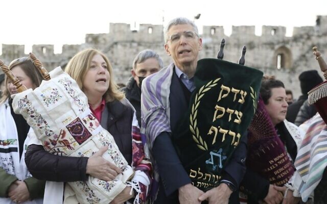 Women of the Wall leader Anat Hoffman and URJ president Rabbi Rick Jacobs hold Torah scrolls at the Western Wall complex on March 4, 2022. (Rick Jacobs/Twitter)