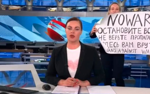 Marina Ovsyannikova, a Russian state TV employee interrupts the evening news broadcast, holding a sign condemning President Vladimir Putin's war against Ukraine on March 14, 2022. (Screen capture/Twitter)