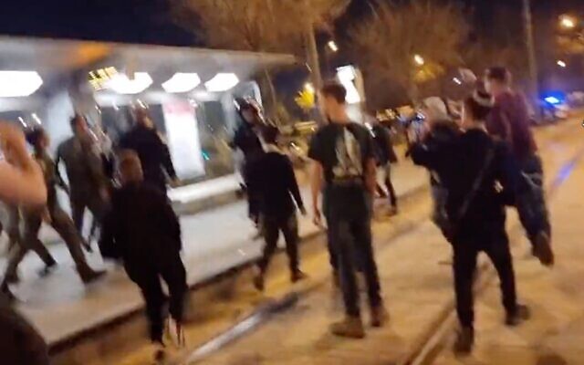 A mob of dozens of young Jewish teens is filmed roaming the streets of downtown Jerusalem, chanting 'death to Arabs,' on March 31, 2022. (Screen capture/Twitter)