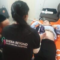 Pregnant patient and Ukrainian refugee Sarah Misk using Sheba Beyond’s telehealth technology in Moldova to talk to doctors in Israel, March 2, 2022. (Sheba Medical Center)