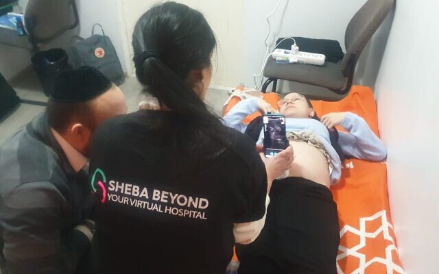 Pregnant patient and Ukrainian refugee Sarah Misk using Sheba Beyond’s telehealth technology in Moldova to talk to doctors in Israel, March 2, 2022. (Sheba Medical Center)