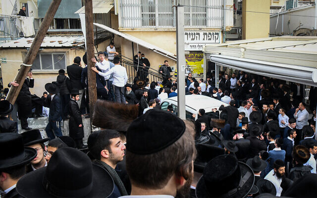People gather outside the home of Rabbi Chaim Kanievsky, in the city of Bnei Brak, on March 18, 2022. Photo by Flash90