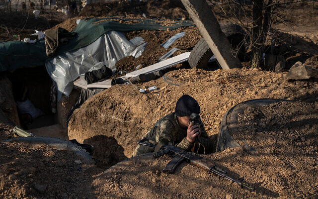 A Ukrainian soldier in a trench on the outskirts of Mykolaiv, Ukraine, March 26, 2022.(AP/Petros Giannakouris)