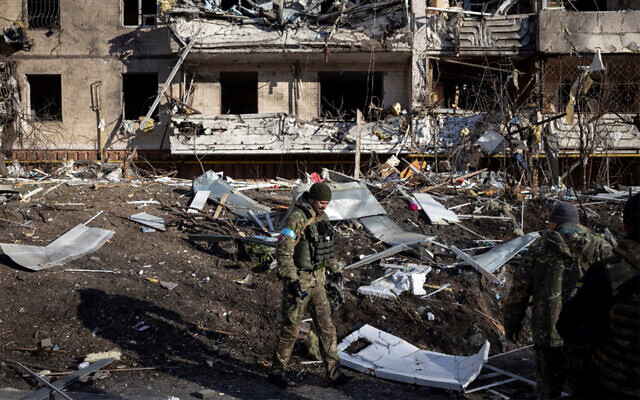 A Ukrainian soldier inspects the rubble of a destroyed apartment building in Kyiv on March 15, 2022. (Fadel Senna/AFP)