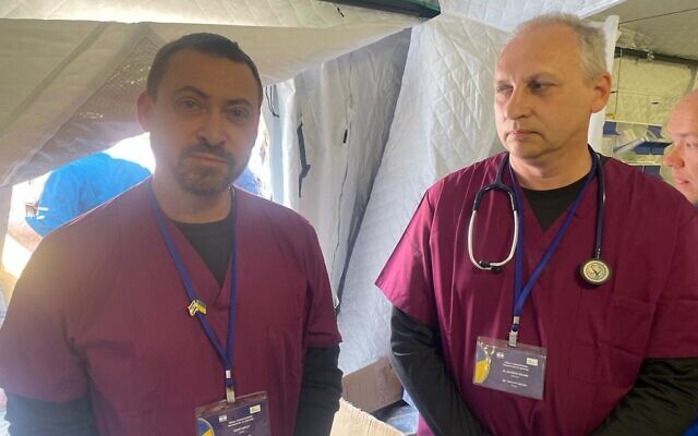 Men: Sergey Mazis (nurse, left), Dr. Eduard Zalyesov on site at Israel's state field hospital in Mostyska, Ukraine, which opened on Tuesday afternoon, March 22, 2022. (Carrie Keller-Lynn/The Times of Israel)