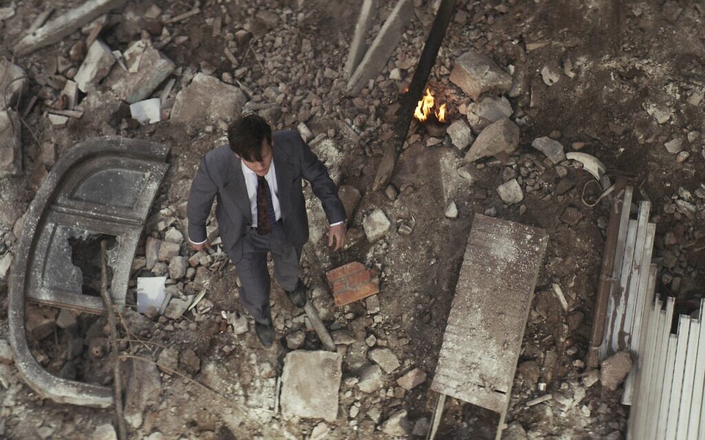 Gustavo Bassani as Yosi in the new Amazon Prime Video series, 'Yosi, the Regretful Spy,' walks in the rubble after the Argentine Israelite Mutual Association attack. (Courtesy Daniel Burman/ Amazon)