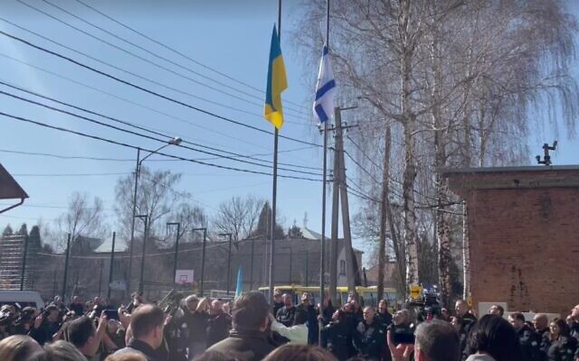 Ukrainian and Israeli flags are raised at a ceremony to open an Israeli field hospital in Mostyska, Ukraine, March 22, 2022 (Screen grab)