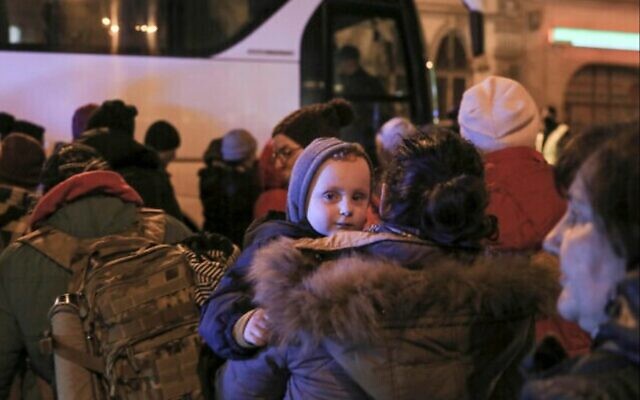 Women and children refugees fleeing the Russian invasion from Ukraine board a bus to Warsaw in Przemysl, Poland, March 1, 2022 (AP Photo/Visar Kryeziu)