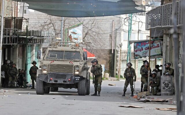 Israeli troops clash clash with Palestinians in the West Bank city of Hebron on April 1, 2022. (Mosab Shawer/AFP)