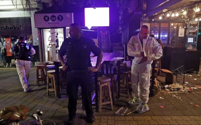 Police and forensics experts at the scene of a deadly terror attack at a cafe on Dizengoff Street in Tel Aviv on April 7, 2022. (JACK GUEZ / AFP)