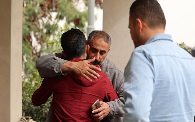 The father of Raad Hazem, 28, a Palestinian terrorist who killed three Israelis and wounded several others in Tel Aviv the previous night, hugs a friend at his home on April 8, 2022 in the West Bank city of Jenin. (JAAFAR ASHTIYEH / AFP)