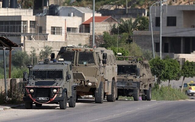 IDF vehicles in the Nur Shams Palestinian refugee camp on April 10,2022, during a raid looking for terror suspects. (JAAFAR ASHTIYEH / AFP)