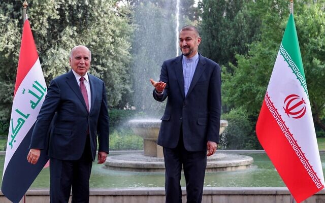 Iranian Foreign Minister Hossein Amir-Abdollahian (R) receives his Iraqi counterpart Fuad Hussein (L) during a welcome ceremony in the capital Tehran, on April 13, 2022. (Atta Kenare/AFP)