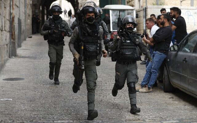 Israeli border police react as they patrol the area in front of the Lion's Gate in Jerusalem's Old City, on April 17, 2022. (Photo by Ahmad GHARABLI / AFP)