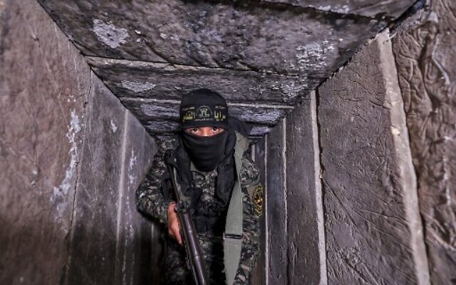 A member of the Palestinian Islamic Jihad terror group walks in a tunnel in the Gaza Strip, on April 17, 2022, during a media tour amid escalating violence with Israel. (Mahmud Hams/AFP)