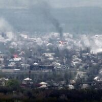 A photograph taken from Novodruzhesk village, shows smoke rising in Rubizhne city, on April 18, 2022, on the 54th day of the Russian invasion of Ukraine. (Ronaldo Schemidt/AFP)