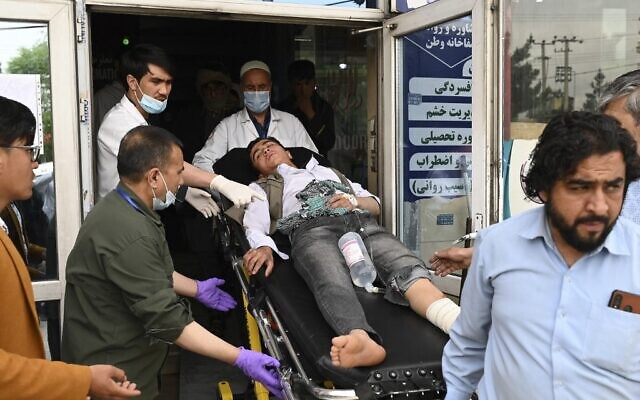 Medical staff move a wounded youth on a stretcher inside a hospital in Kabul, on April 19, 2022, after two bomb blasts rocked a boys' school in a Shiite Hazara neighborhood killing at least 6 people. (Wakil Kohsar/AFP)