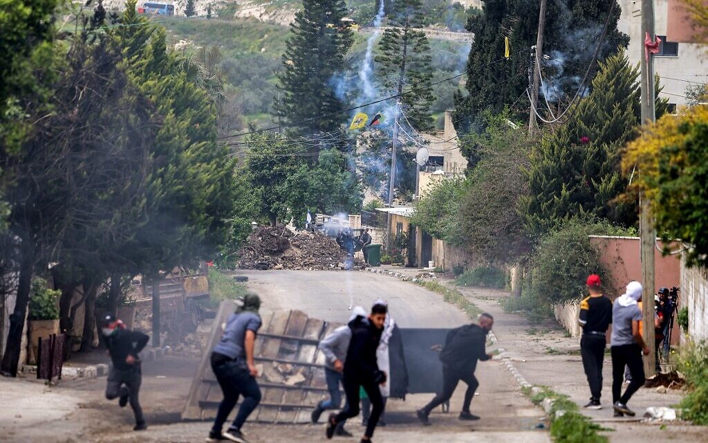 Israeli forces fire tear gas at Palestinian protesters gathering in the West Bank against a march by Israelis to the wildcat settlement outpost of Homesh on April 19, 2022. (JAAFAR ASHTIYEH / AFP)