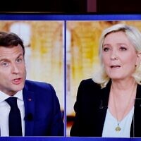 A picture shows a TV screen  displaying a live televised between French President and La Republique en Marche (LREM) party candidate for re-election Emmanuel Macron (L) and French far-right party Rassemblement National (RN) presidential candidate Marine Le Pen (R), on April 20, 2020. (Ludovic MARIN / AFP)