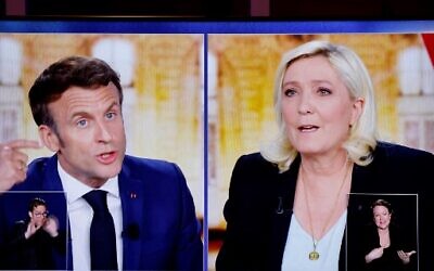 A picture shows a TV screen  displaying a live televised between French President and La Republique en Marche (LREM) party candidate for re-election Emmanuel Macron (L) and French far-right party Rassemblement National (RN) presidential candidate Marine Le Pen (R), on April 20, 2020. (Ludovic Marin/AFP)